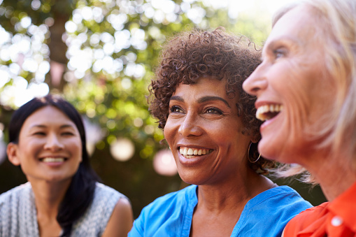 A group of smiling older women with dental implants from David Paulussen, DMD in Hackettstown, NJ